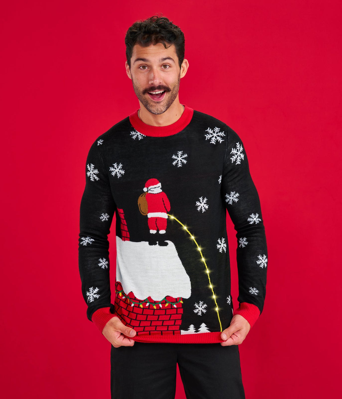 Man wearing a festive sweater with Santa Claus design on a red background