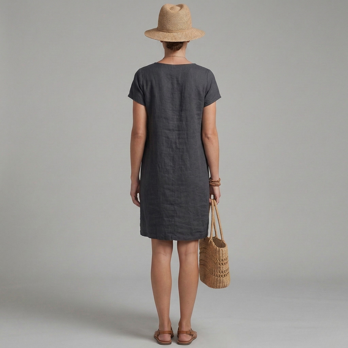 Stylish women's summer mini dress featuring short sleeves and front pockets. Ideal for comfortable, versatile casual fashion.