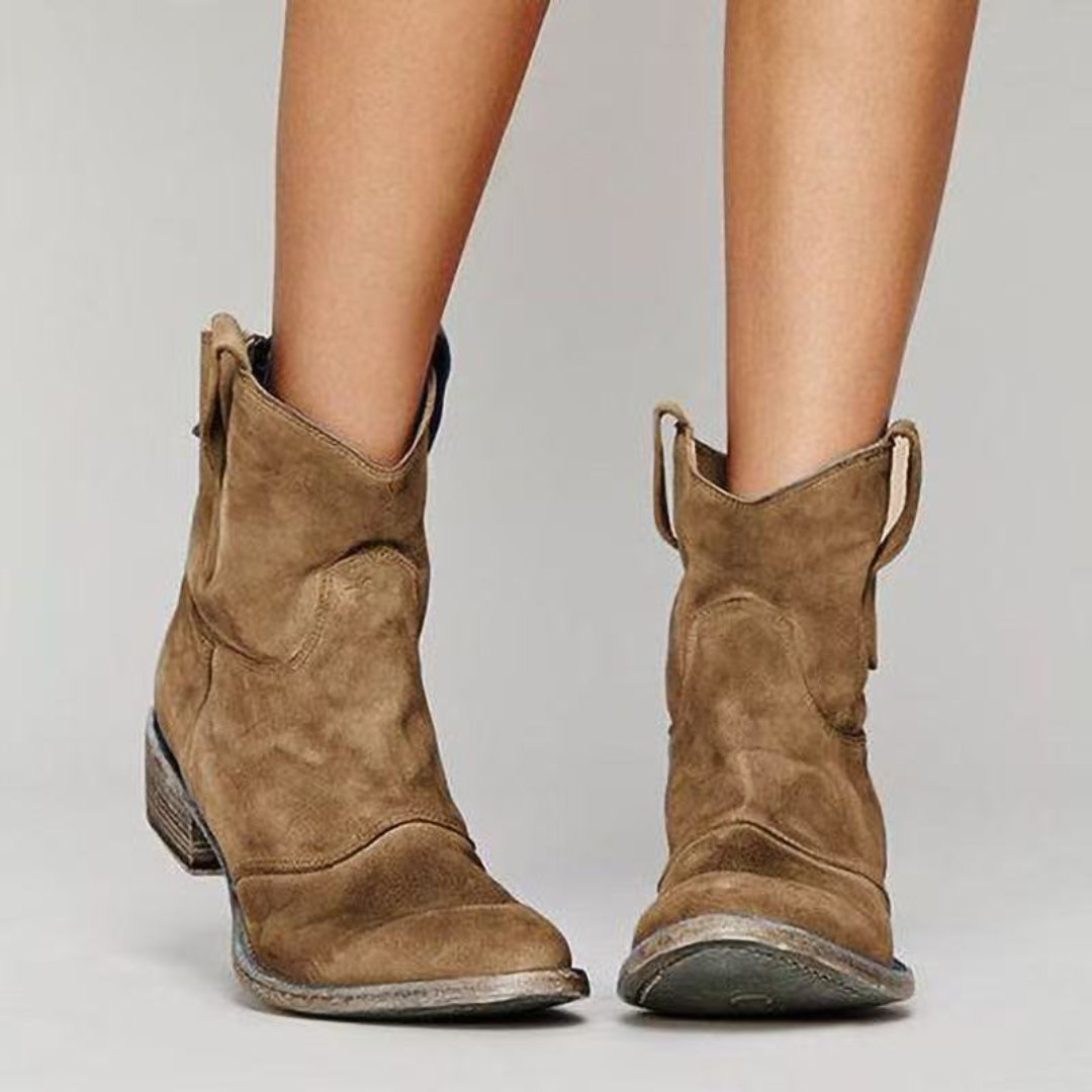Stylish women's Western ankle boots with pull tabs, low heel, and rounded toe.