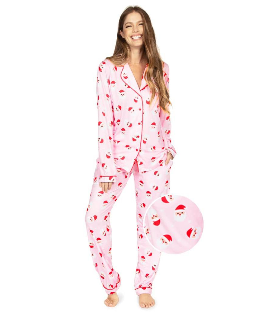Woman wearing a pink pajama set with cherry pattern on a white background