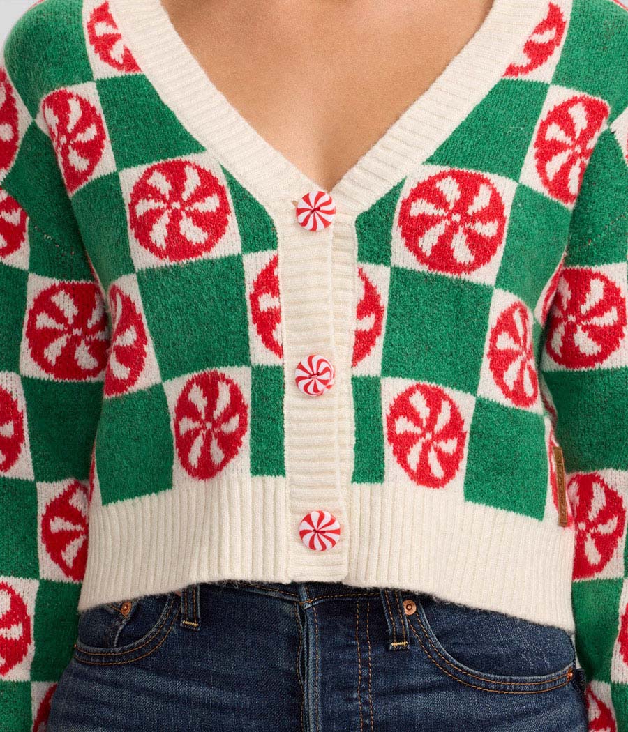 Green and red patterned sweater with a checkered design