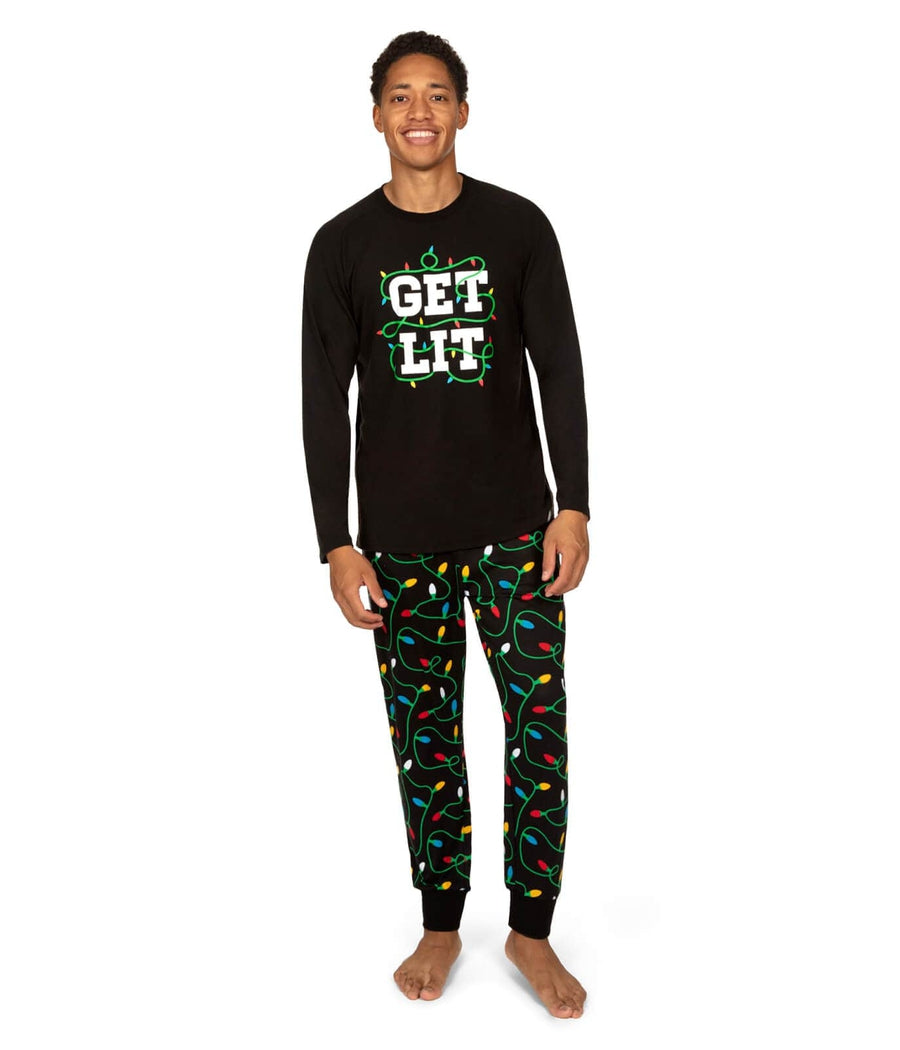Person wearing a black long-sleeve shirt with 'GET LIT' text and colorful pajama pants on a white background